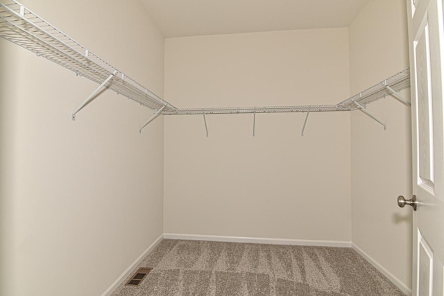 walk in closet with light carpet and visible vents