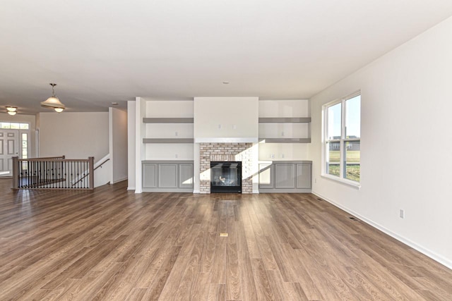 unfurnished living room with a fireplace and wood finished floors