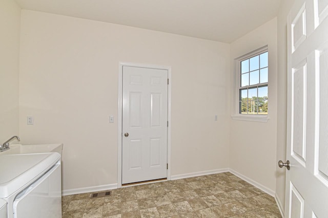 laundry area featuring laundry area, a sink, visible vents, baseboards, and independent washer and dryer