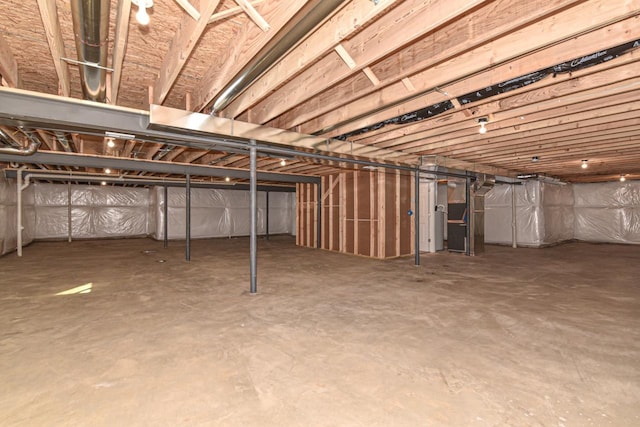 unfinished below grade area featuring heating unit