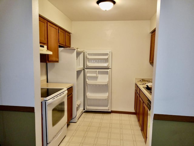 kitchen featuring light floors, white electric range oven, light countertops, brown cabinetry, and under cabinet range hood