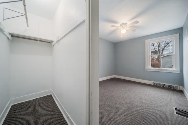 spacious closet featuring carpet floors, visible vents, and attic access