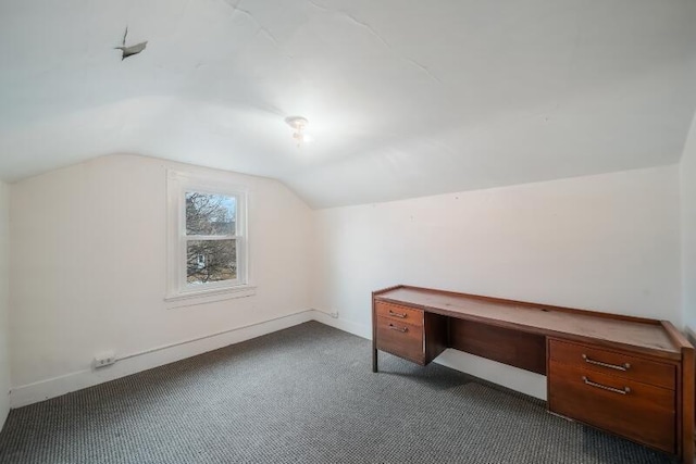 additional living space featuring lofted ceiling, baseboards, and dark colored carpet