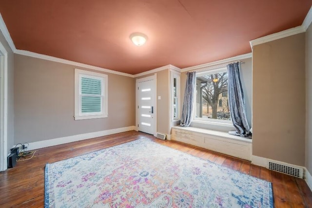 interior space with visible vents, crown molding, and wood finished floors