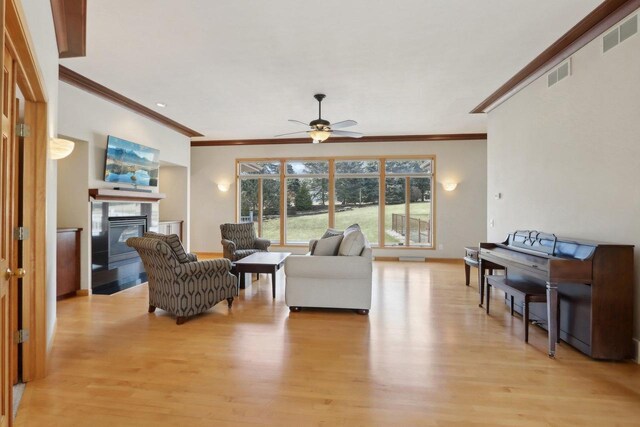 4707 Plainfield Ct, Middleton, WI 53562 - living area with visible vents, ornamental molding, and light wood-style flooring