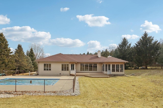 4707 Plainfield Ct, Middleton, WI 53562 - back of property with a sunroom, a yard, fence, a chimney, and a fenced in pool