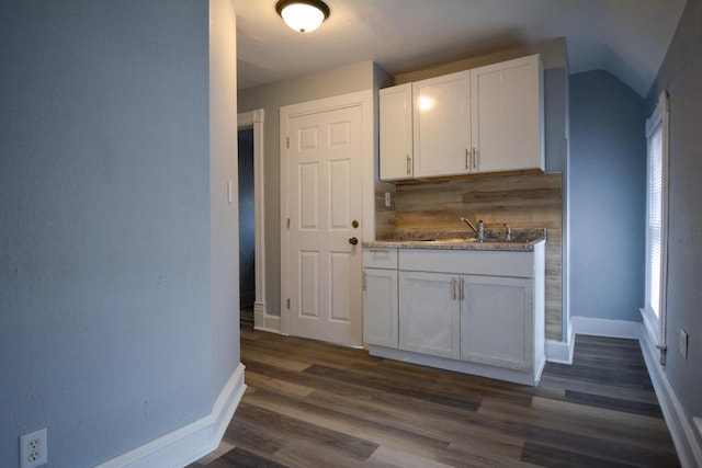 kitchen featuring dark wood-style flooring, plenty of natural light, a sink, and white cabinets