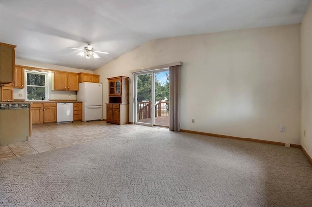 kitchen with light carpet, white appliances, a ceiling fan, baseboards, and vaulted ceiling