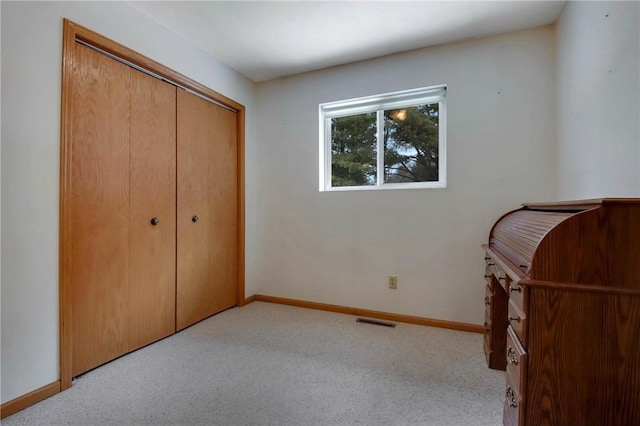 unfurnished bedroom with carpet, visible vents, and baseboards