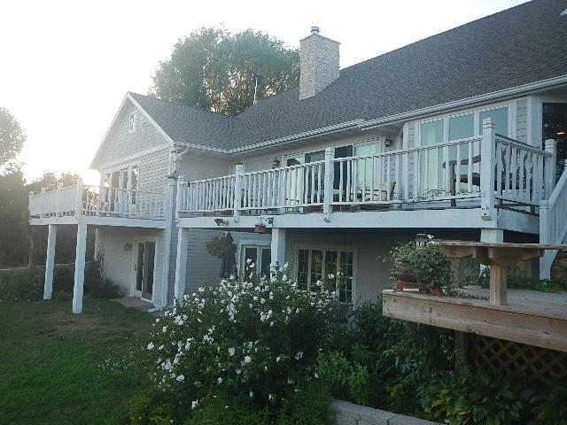 back of property with a wooden deck and a chimney