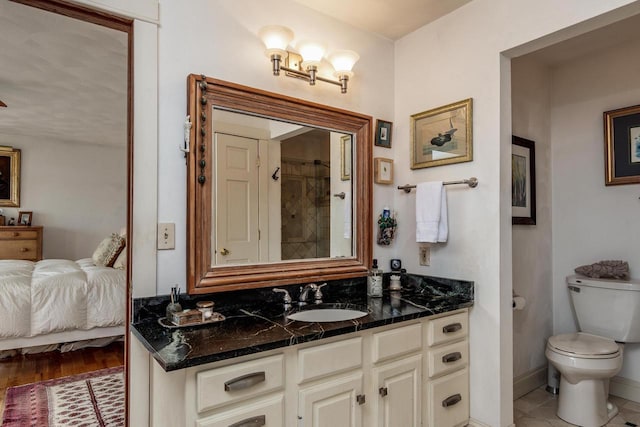 full bathroom with baseboards, toilet, ensuite bath, and vanity