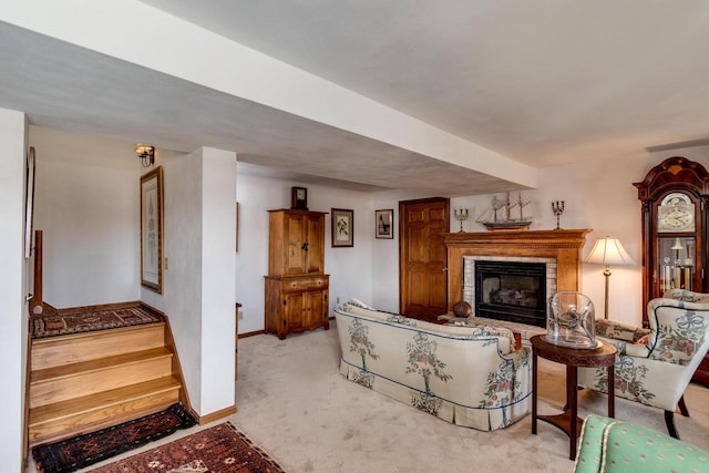 living area featuring carpet flooring, a fireplace, and baseboards