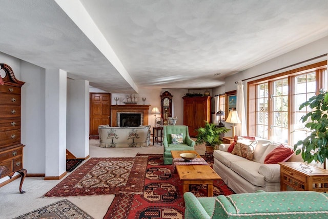 living area featuring carpet, a fireplace, and baseboards