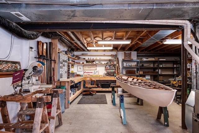 unfinished basement featuring a workshop area