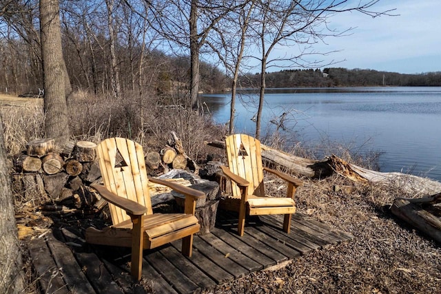 wooden deck with a forest view and a water view