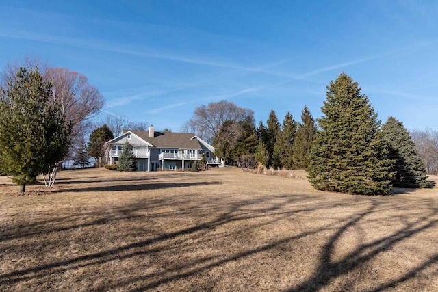 exterior space featuring a wooden deck and a front lawn