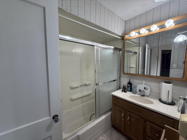 full bathroom featuring vanity, shower / bath combination with glass door, wallpapered walls, tile patterned floors, and backsplash