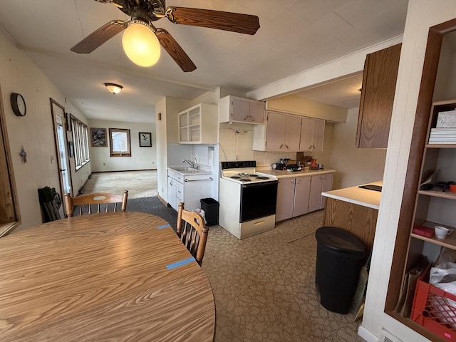 kitchen featuring ceiling fan, light countertops, decorative backsplash, white range with electric stovetop, and a sink