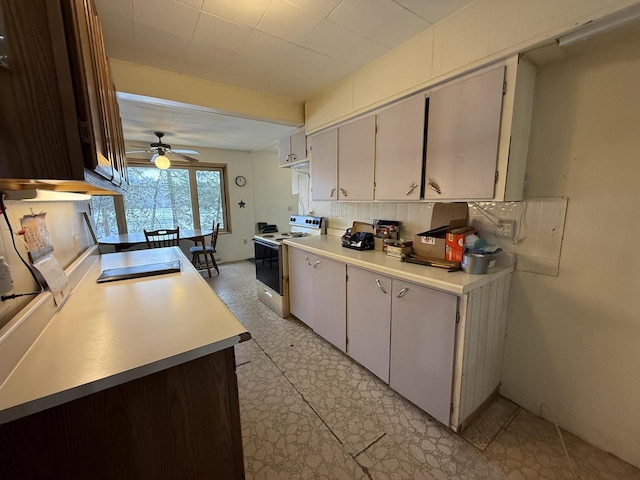 kitchen with a ceiling fan, white electric range, tasteful backsplash, light countertops, and light floors