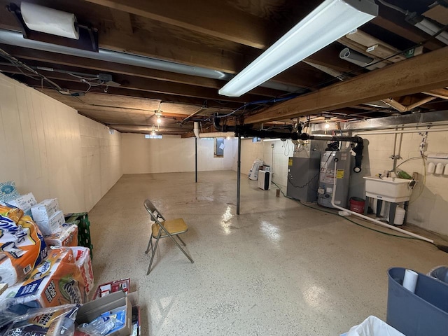 unfinished below grade area featuring gas water heater, heating unit, and a sink