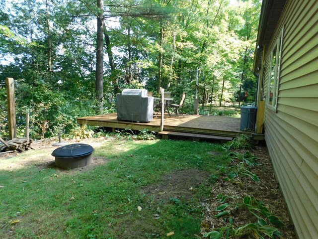 view of yard featuring a fire pit and a deck