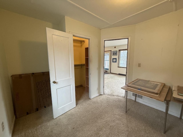 interior space with baseboards and carpet flooring