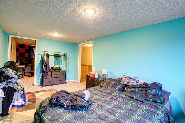 carpeted bedroom featuring a textured ceiling