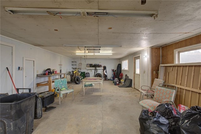 interior space with a garage and wooden walls