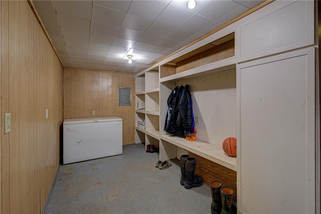 mudroom with electric panel and wood walls