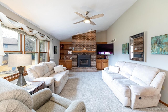 carpeted living room featuring ceiling fan, a fireplace, visible vents, and vaulted ceiling