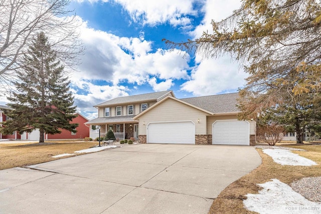 view of front of house with a front yard, concrete driveway, brick siding, and an attached garage