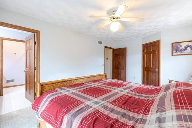 bedroom with baseboards, visible vents, and a ceiling fan