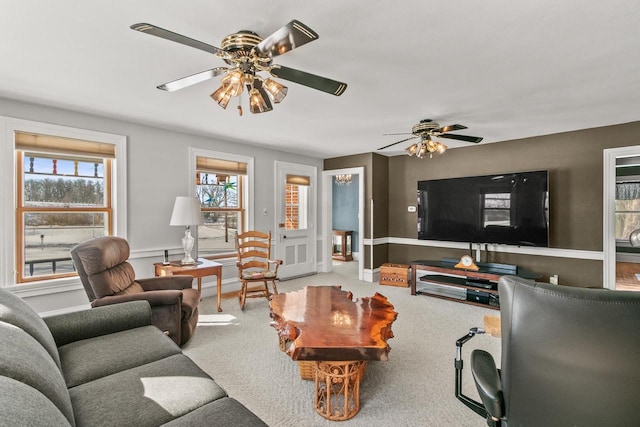 living room with carpet floors, ceiling fan, and baseboards