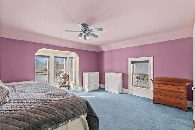 carpeted bedroom with baseboards and a ceiling fan