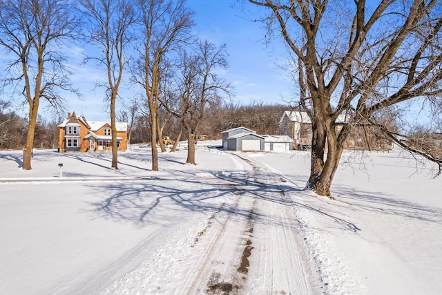 yard layered in snow with an outdoor structure