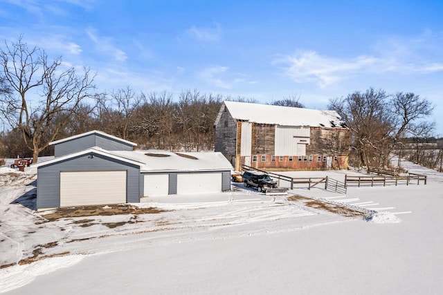 view of front of house featuring a garage and an outdoor structure