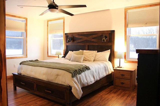 bedroom featuring a ceiling fan and dark wood-style flooring