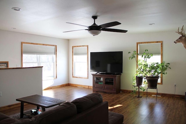 living area featuring ceiling fan, baseboards, and wood finished floors