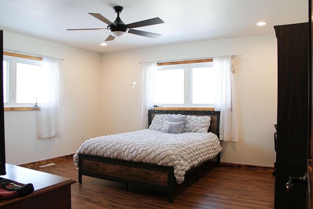 bedroom featuring multiple windows, dark wood finished floors, and recessed lighting