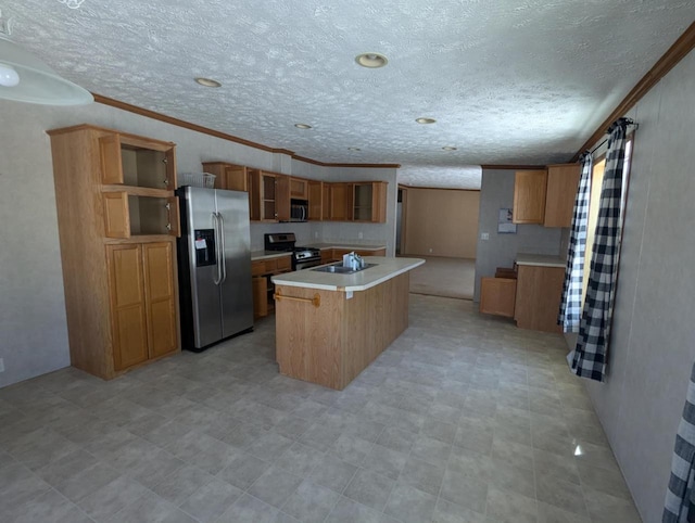 kitchen with brown cabinets, open shelves, light countertops, appliances with stainless steel finishes, and an island with sink