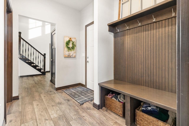 mudroom featuring light wood-style floors and baseboards