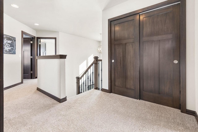 carpeted foyer featuring baseboards and recessed lighting