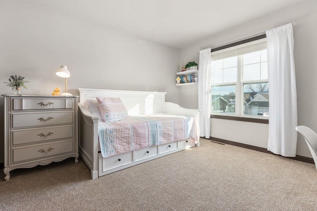 carpeted bedroom featuring visible vents and baseboards