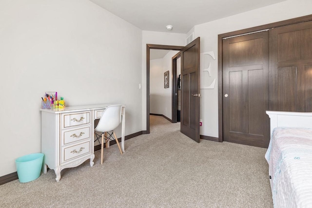 bedroom featuring baseboards, a closet, and light colored carpet