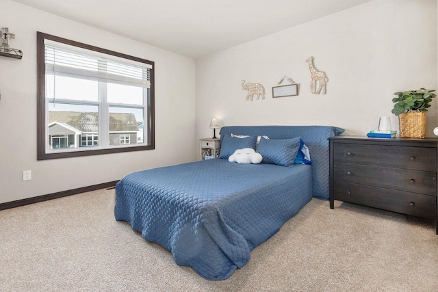 carpeted bedroom featuring baseboards