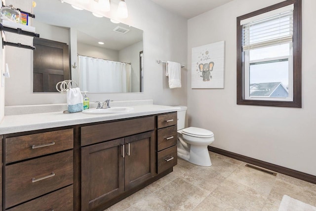 full bathroom with toilet, vanity, visible vents, and baseboards