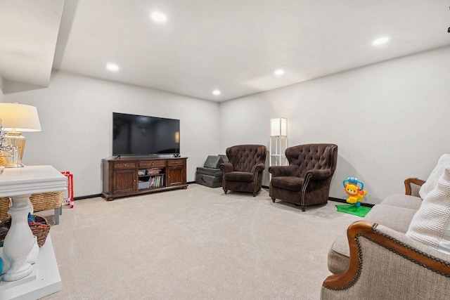 living area with recessed lighting, light carpet, and baseboards