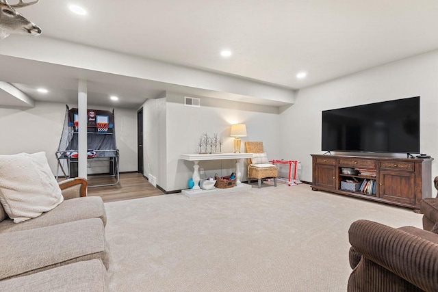 carpeted living room with baseboards, visible vents, and recessed lighting