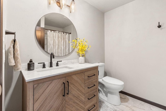 bathroom with marble finish floor, baseboards, vanity, and toilet