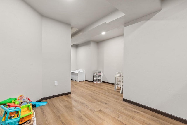 rec room featuring wood finished floors and baseboards